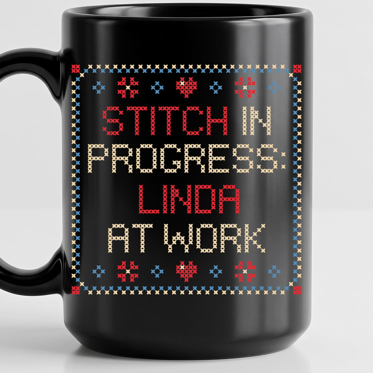 "Stitch in progress: [Name] at work" - Faux Cross Stitch Coffee Cup | Custom Name Mug