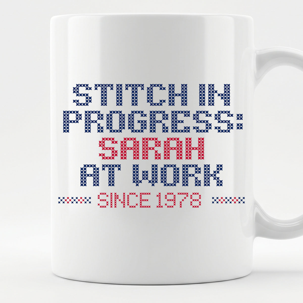 "Stitch in progress: [Name] at work. Since [Year]" - Faux Cross Stitch Mug | Personalized Gift