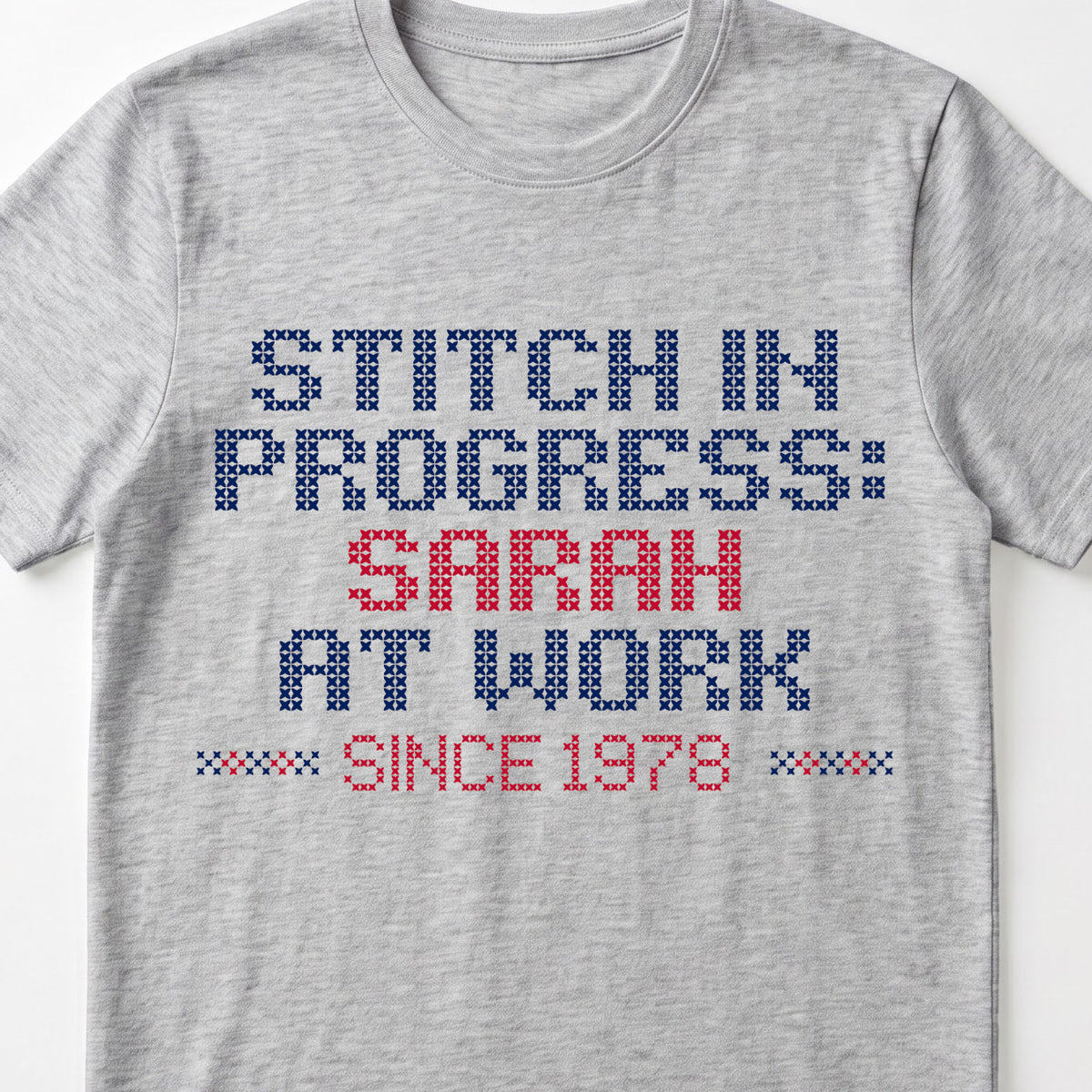 "Stitch in progress: [Name] at work. Since [Year]" - Faux Cross Stitch T-Shirt | Personalized Gift