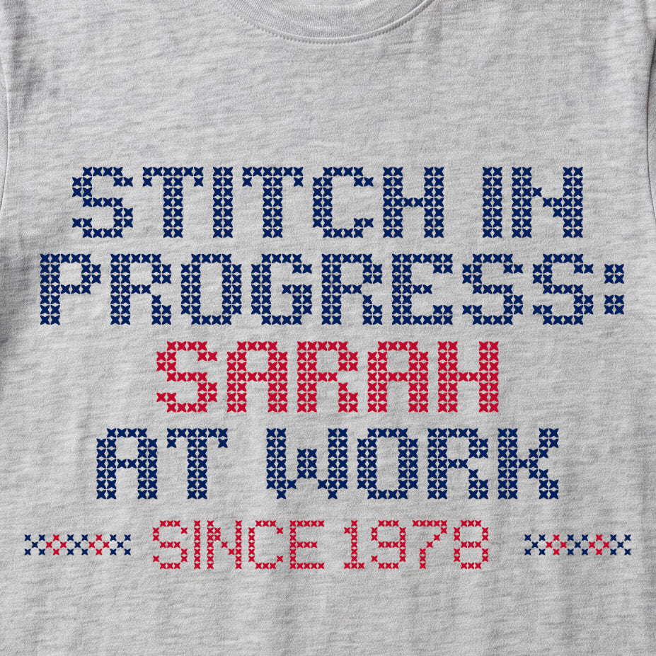 "Stitch in progress: [Name] at work. Since [Year]" - Faux Cross Stitch T-Shirt | Personalized Gift